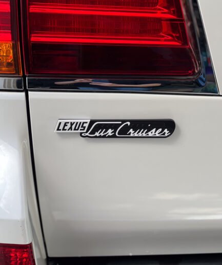 Close-up of ASA 3D printed Luxury Cruiser badge with clear coat finish for Lexus LX570